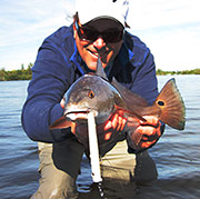 John Donahue with redfish caught with Bone Skid Stik